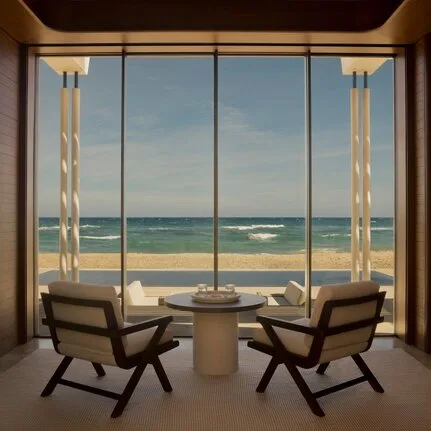 Beachfront casita at Amanvari with two chairs facing expansive sea views through floor-to-ceiling windows.