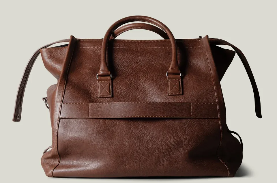 Brown leather bag on a light gray background
