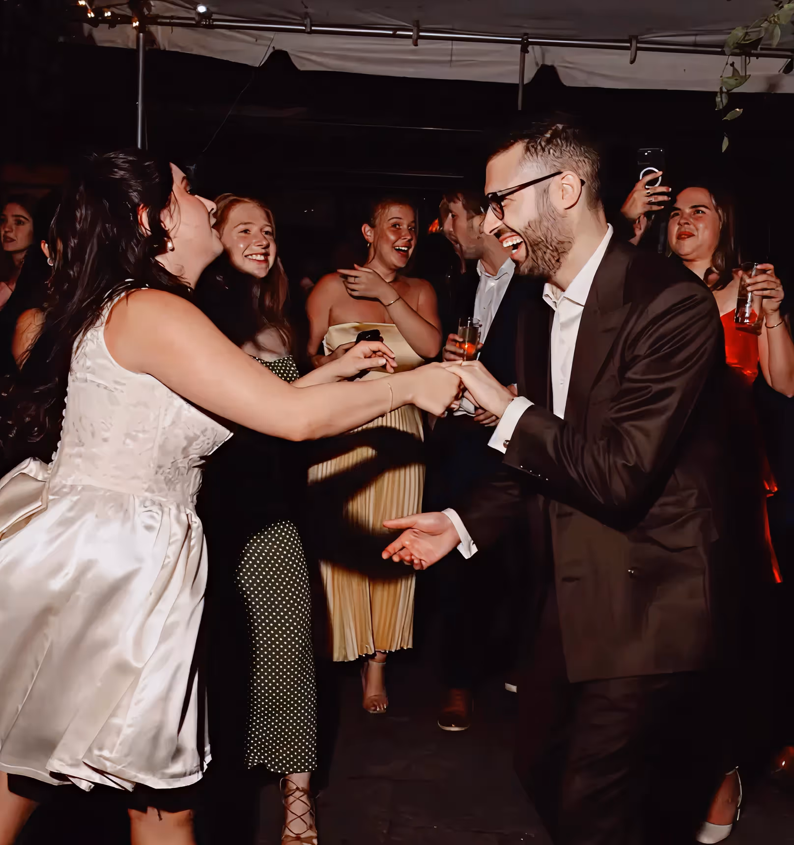 Happy guests dancing during a festive private event hosted at Roberta’s Pizza restaurant.